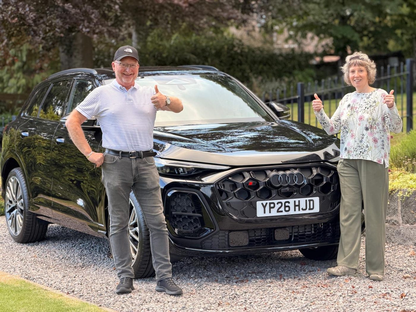 Happy customers receiving an Audi